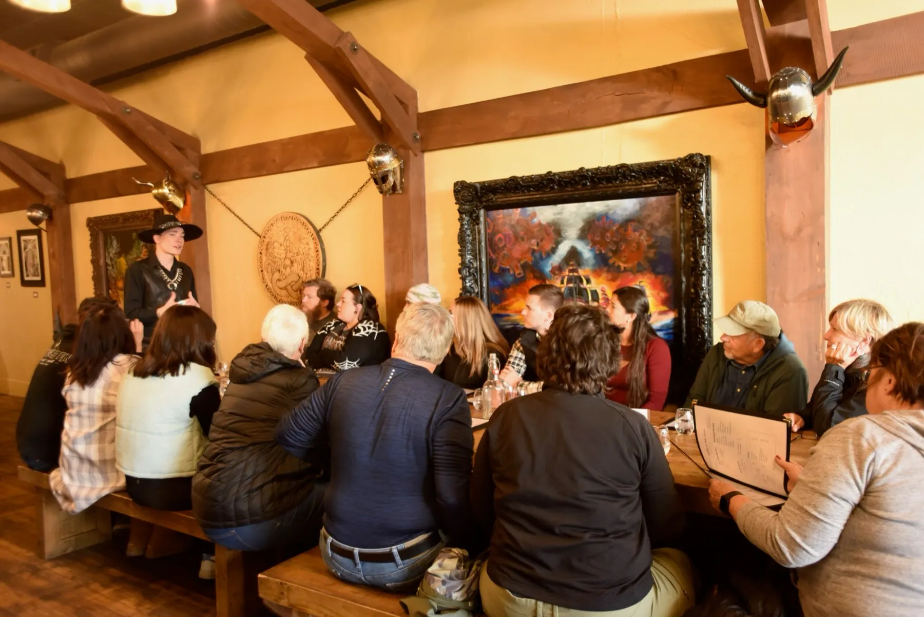 A costumed Freaky Foot Tours guide telling ghost stories to pub crawl guests over drinks at a Flagstaff bar